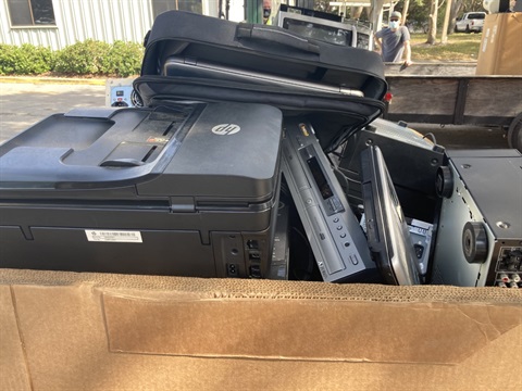 This is a photo of a pile of broken TVs, computers, laptops, and other electronic waste.