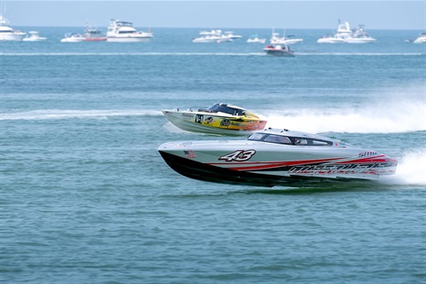 A speed boat racing in the water