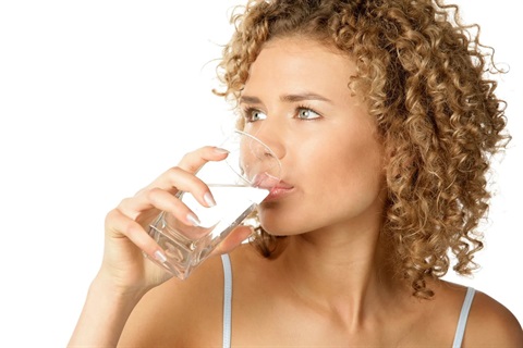 Image of a woman drinking a glass of water